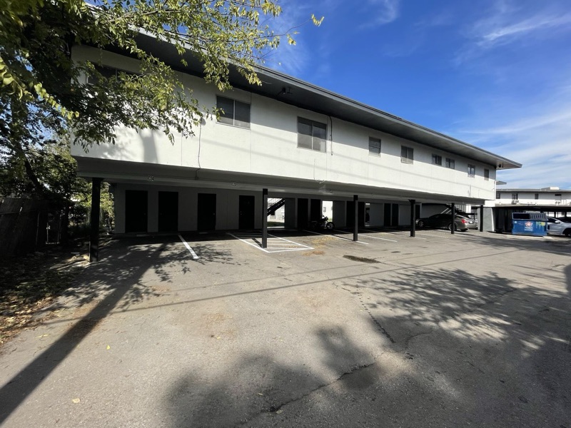The long two-story La Bella block seen down the length of the car park.